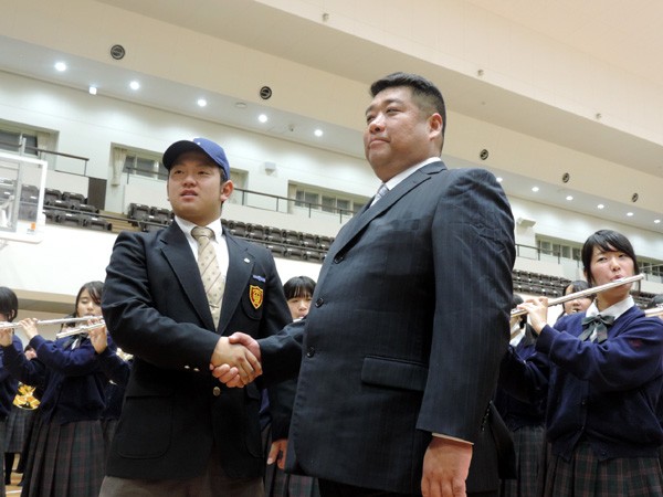 森は会見後、西武の帽子をかぶり、西谷監督と握手する